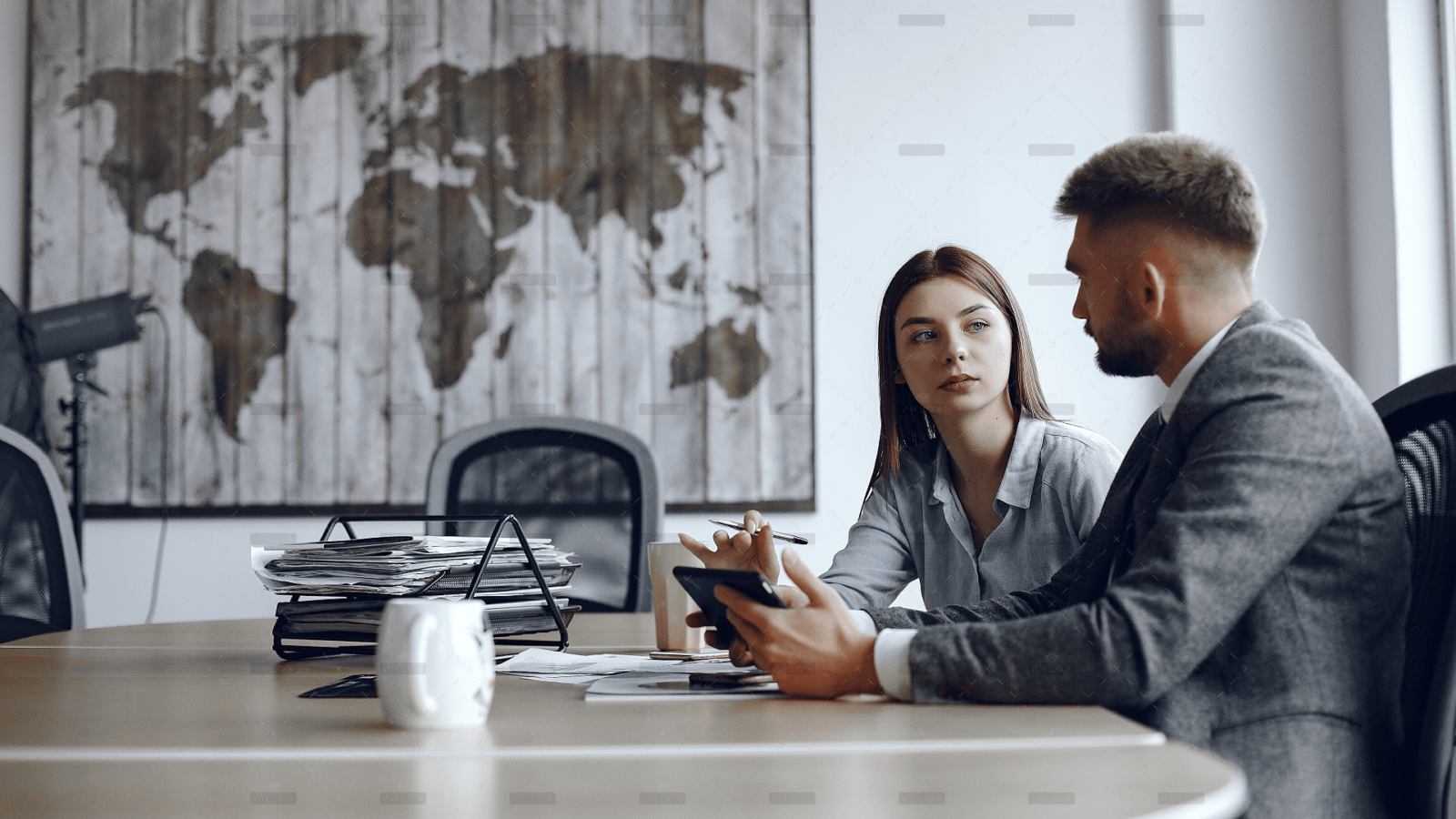 man-uses-tablet-business-partners-business-meeting-people-are-sitting-table.png